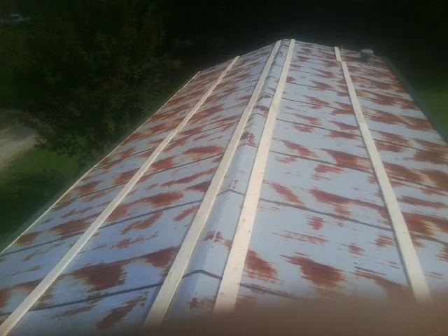 Rusted metal roof panels with new wood purlins before replacement — Storm Damage Roof Repair in Mc Alisterville by Roofing Brothers